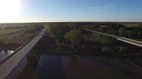 4k aerial smooth view of double highway over river Stock Footage 55605647