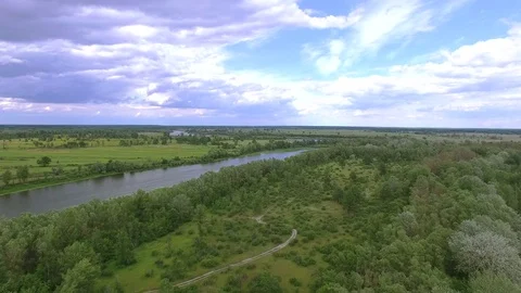 4K Aerial. Spring  or summer river and green field with trees.  Stockbeeldmateriaal 77624055