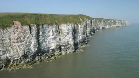 4K aerial static shot of white chalk cliffs with ocean Stock Footage 200026528