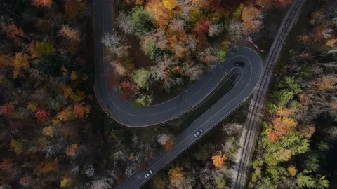 4K aerial straight down over steep hairpin curves as cars turn around it slowly  Video stock 150130689