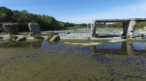 4k aerial through broken train bridge and river bed Stock Footage 55373628