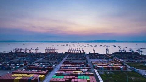 4K Aerial Timelapse of Busy Work at Container Logistics Terminal at Dawn Stock Footage 345470348