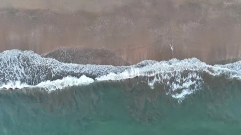 4K Aerial Top-Down: Gentle waves on beach at sunset in Punta Umbria Spain. Stock Footage 333637604