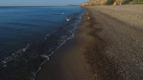 4k aerial top down view moving forward over mediterranean coastline cliff edge Stock Footage 108674430