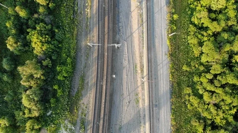 4k Aerial top down view of empty railway along the forest in summer at sunset Stock Footage 123879383