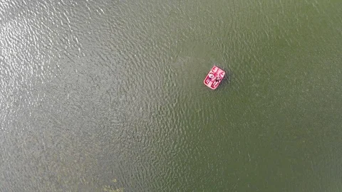 4k Aerial top down view of people on the red sail catamaran on lake on Sunny day Stock Footage 123986227