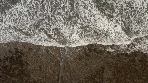 4K Aerial top down view of Devon coast and tide Stock Footage 126698551