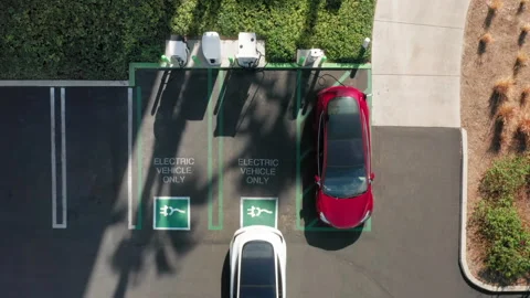 4K aerial top down view on electric car parking at the charging station, USA Stock Footage
