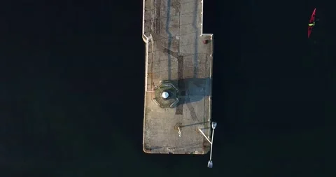 4k aerial top down view of Anstruther pier with solitary kayaker paddling Stock Footage 150805219