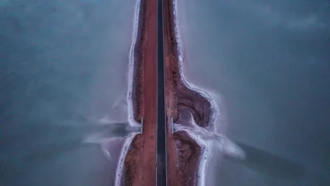 4K aerial Top Down view of empty road and salt water lake on both sides, connect Stock Footage 329117198