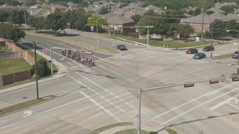 4K Aerial Top View of Group of Bicyclists Stopping at Street Intersection Stock Footage 241680992