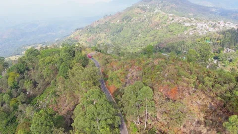 4K Aerial Tracking of Red Bus on Scenic Morning Mountain Route in Sri Lanka Stock Footage 322183995