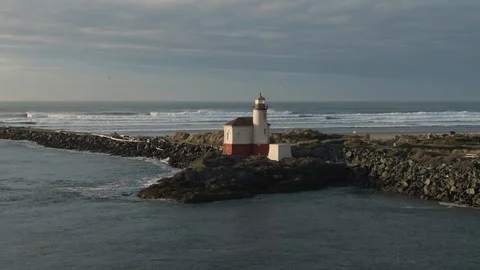 4k Aerial tracking shot of the lighthouse in Bandon, Oregon at sunset Stock Footage 99573796