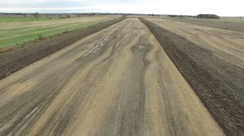 4k aerial tractor plows backwards passover Stock Footage 56860013