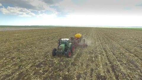 4K Aerial Of Tractor Pulling Disc Seeder Plough-Front Shot Stock Footage 83607819