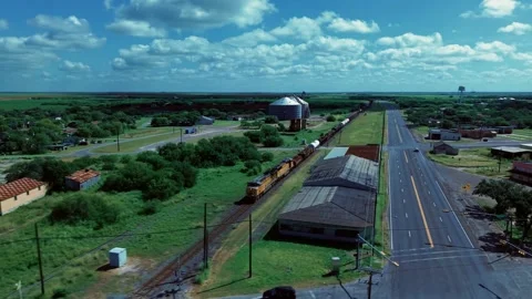 4K Aerial of Union Pacific Freight Train Passing Through Bishop, Texas on 7/4/26 Stock Footage 338261985