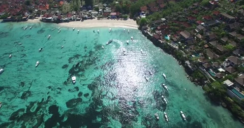 4K AERIAL VERTICAL FLY OVER OF BLUE OCEAN, BOATS AND HOUSES NEAR BEACH Stock Footage 60044220