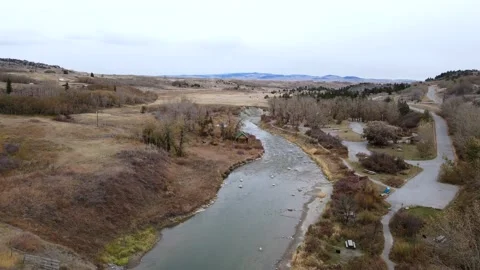 4k aerial video approaching a tiny wooden cabin on a riverbank. Slowed Stock Footage 165810455