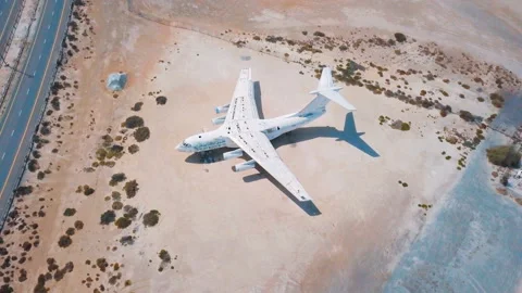 4K aerial video of an old broken abandoned airplane in the desert. Flying over Stock Footage 90017847