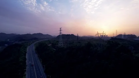 4K aerial video of power grid transmission with sunrise and morning glow Video stock 334899321