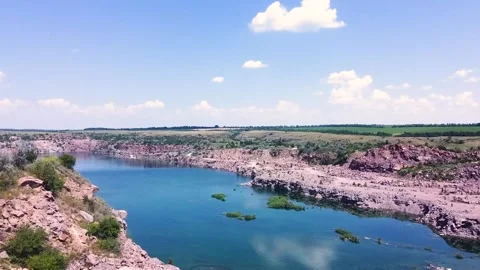 4K aerial video. Slow flight by drone over a large abandoned granite quarry. Stock Footage 133908948