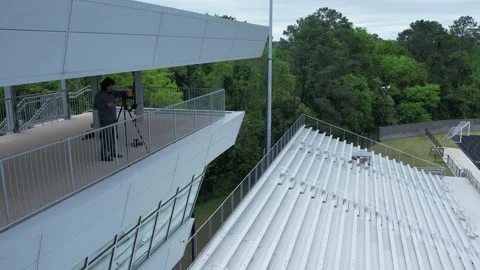 4K aerial of a videographer camera operator setting up a livestream Stock Footage 218369066