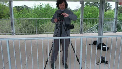 4K aerial of a videographer camera operator setting up a livestream Stock Footage 218369103