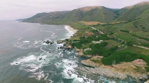 4k aerial view along side big sur rocks waves Видео 65481968