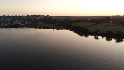 4K Aerial View Approaching Cornish Town from River Bank Stock Footage