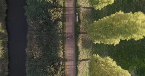 4K Aerial View of Cyclists on a Pathway at Sunset Stock Footage 245442461