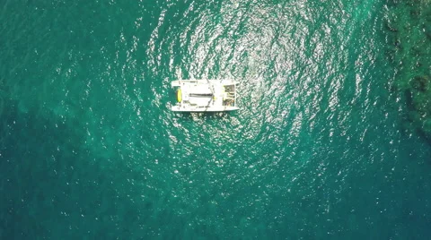 4K aerial view of diving tour boat and tilt up to horizon Stock Footage 63355255