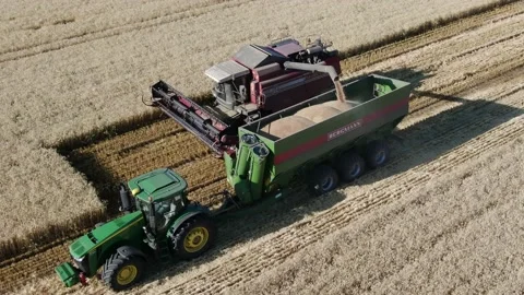 4k Aerial view from the drone to a combine agriculture machine harvesting golden Stock Footage 158171439