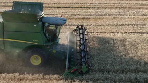 4k Aerial view from the drone to a combine agriculture machine harvesting golden Stock Footage 158172639