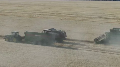4k Aerial view from the drone to a combine agriculture machine harvesting golden Stock Footage 158174375
