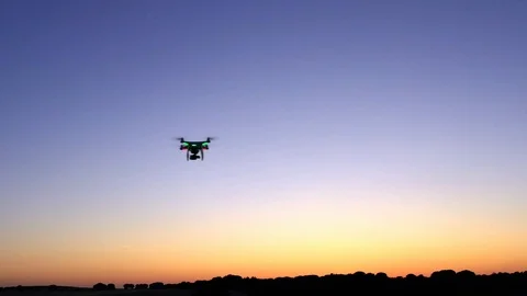 4K, Aerial view of drone flying with digital camera over a field with sunset-Dan Stock Footage 111051642