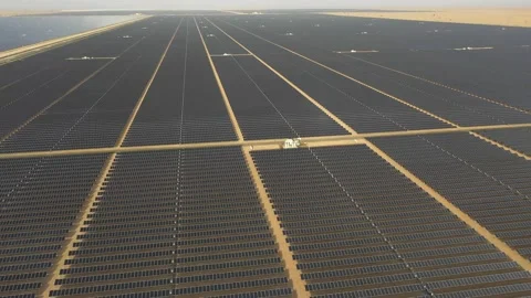 4K Aerial view from a drone flying over a solar farm in a desert. Stock Footage 131364231