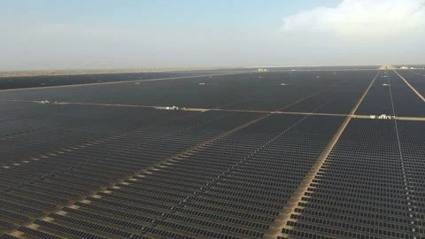 4K Aerial view from a drone flying over a solar farm in a desert. Stock Footage 131364245