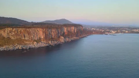 4K Aerial View of Eastern Walls of Bagsugijeong Cliff During Sunset, Jeju. Stock Footage 146068517