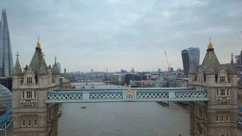 4K aerial view of famous Tower Bridge on a cloudy morning with skyscrapers Stock Footage 87620267