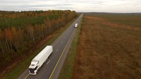 4K aerial view – flight over highway near autumn forest. Road vehicles traffic Stock Footage 57098481
