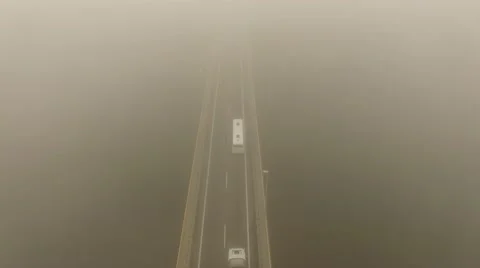 4K aerial view – flight over misty morning bridge showing road vehicles moving Stock Footage 57098707