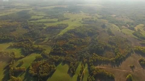 4K aerial view flying over harvested fields in countryside in sunny weather Stock Footage 141902468