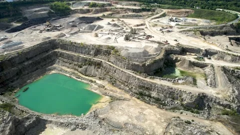 4K Aerial view of a FULLY OPERATING Quarry. Trucks Driving around in Frame. Stock Footage 210080337
