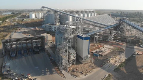 4K Aerial view of grain elevators near the sea port. Metal tanks of elevator Stock Footage 115331149