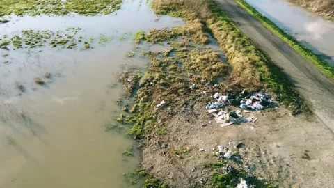 4k aerial view of Illegal Dumped household garbage near a flooded fields Vidéo 147881107