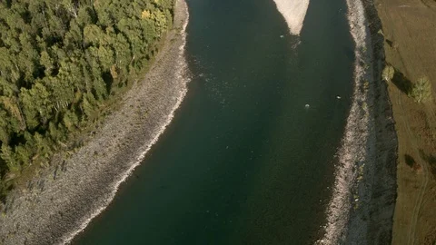 4K aerial view. Low flight over a cold mountain river Mountains trees and sky Stock Footage 123129011