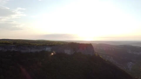 4K aerial view of mountains next to cliff cliff during sunset. Video stock 155608511