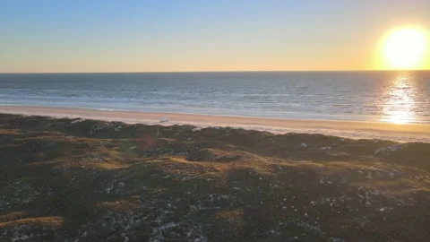 4K Aerial View of Ocean. Sandy Beach with Van and Dunes. Sunrise. Dolly Shot Pan Stockbeeldmateriaal 146175913