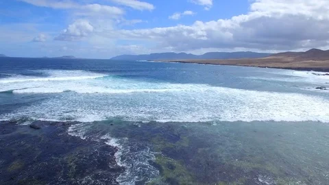 4K Aerial view of ocean waves in sunny Canary Island - Lanzarote Stock Footage 123469372