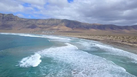 4K Aerial view of ocean waves in sunny Lanzarote - Famara Village Video stock 123469952